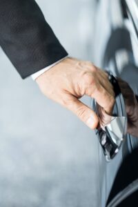 Opening car. Close-up of hand holding the car handle